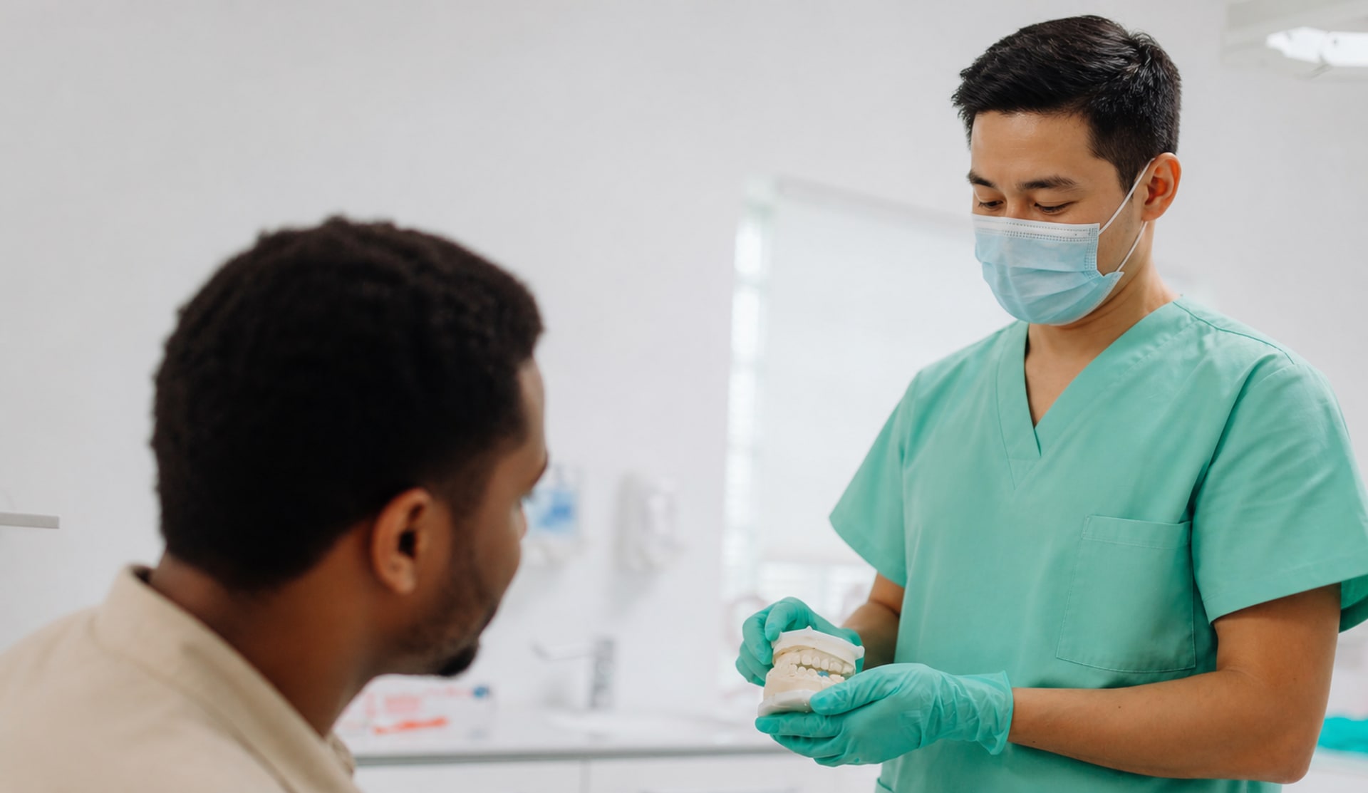 A dentist walking a patient through the plan at Northbeam